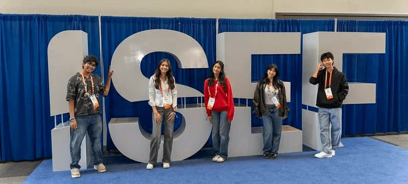 Four ISEF finalists standing in front of the ISEF sign